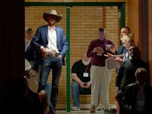 (Francisco Kjolseth | The Salt Lake Tribune) Carson Jorgensen, GOP Chair, wearing a cowboy hat, joins delegates on the edge of a packed auditorium at Kearns High School for the Salt Lake County Republican convention on Saturday, April 9, 2022. Jorgensen is stepping aside as party boss after one term.