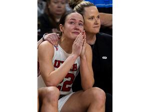 (Mic Smith | AP) Utah's Jenna Johnson (22) holds back tears and is comforted by coach Lynne Roberts after missing two free throws late in the second half against LSU in a Sweet 16 college basketball game of the women's NCAA Tournament in Greenville, S.C., Friday, March 24, 2023.
