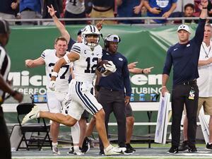 (Jason Behnken | AP) BYU wide receiver Puka Nacua (12) scores on a 75-yard touchdown during the first half of the team's NCAA football game against South Florida on Saturday, Sept. 3, 2022, in Tampa, Fla.