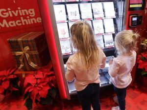 (The Church of Jesus Christ of Latter-day Saints)
Two girls look at the many options available for purchase in a Giving Machine in Calgary, Canada. Canada was one of 28 locations around the world in 2022 where donations were made during the Christmas season. A new study suggests religion can prompt people to be more generous to outsiders.
