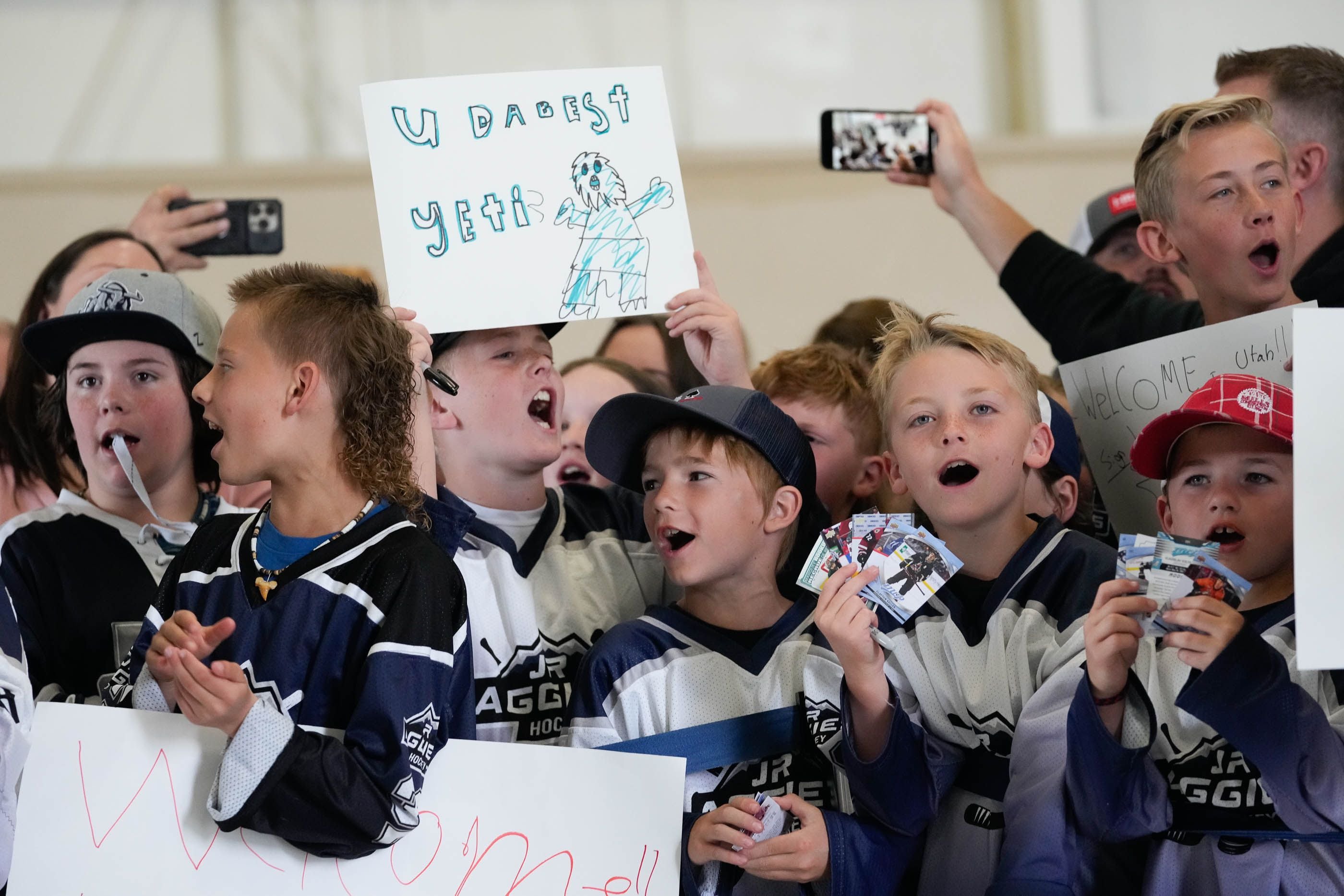 (Francisco Kjolseth  |  The Salt Lake Tribune) Young hockey fans cheer on Utah’s new NHL team as they celebrate their arrival at the airport in Salt Lake City on Wednesday, April 24, 2024.