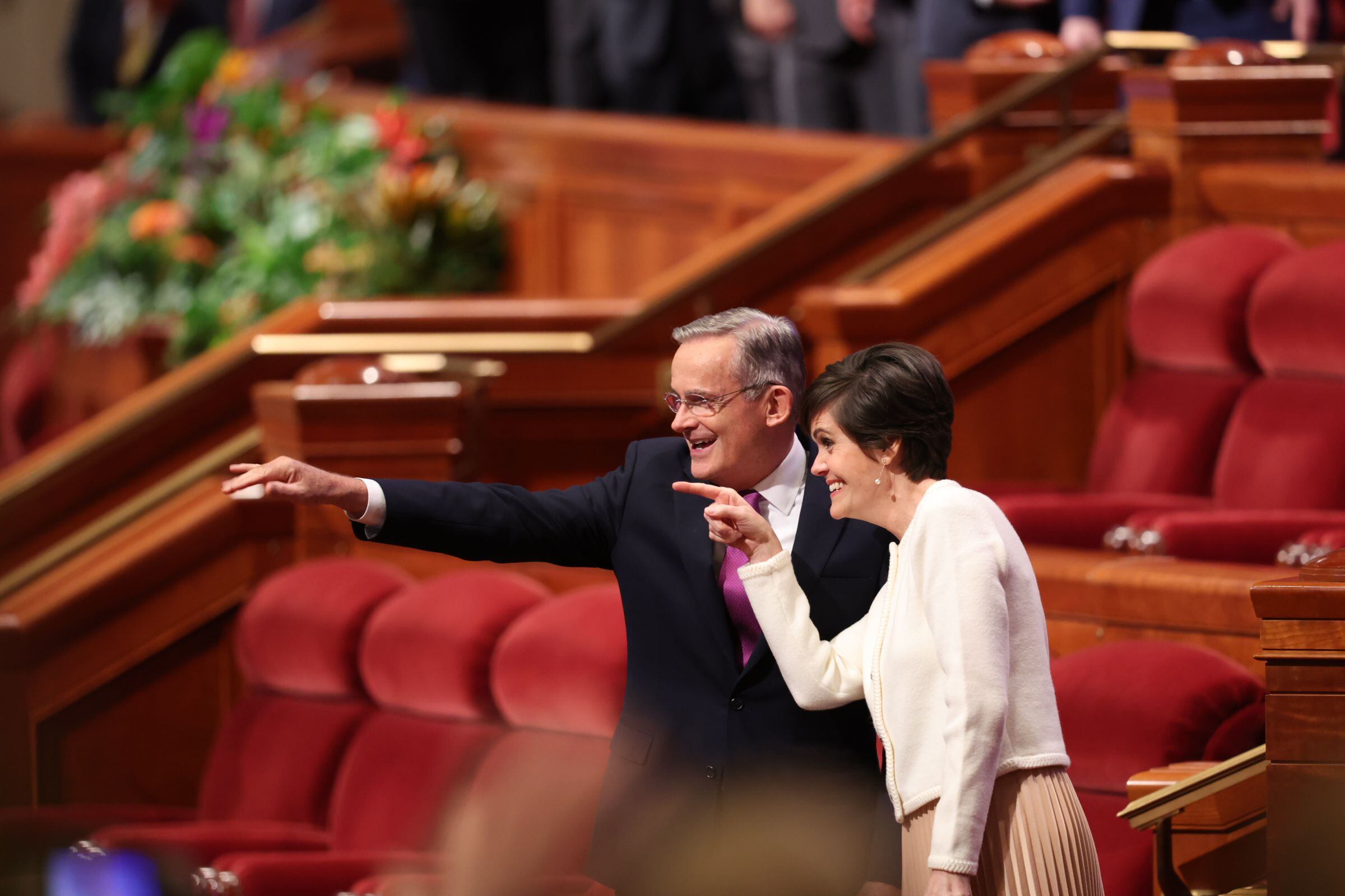 (The Church of Jesus Christ of Latter-day Saints) Apostle Patrick Kearon and his wife, Jennifer, look to the Conference Center crowd at General Conference on Sunday, April 7, 2024.