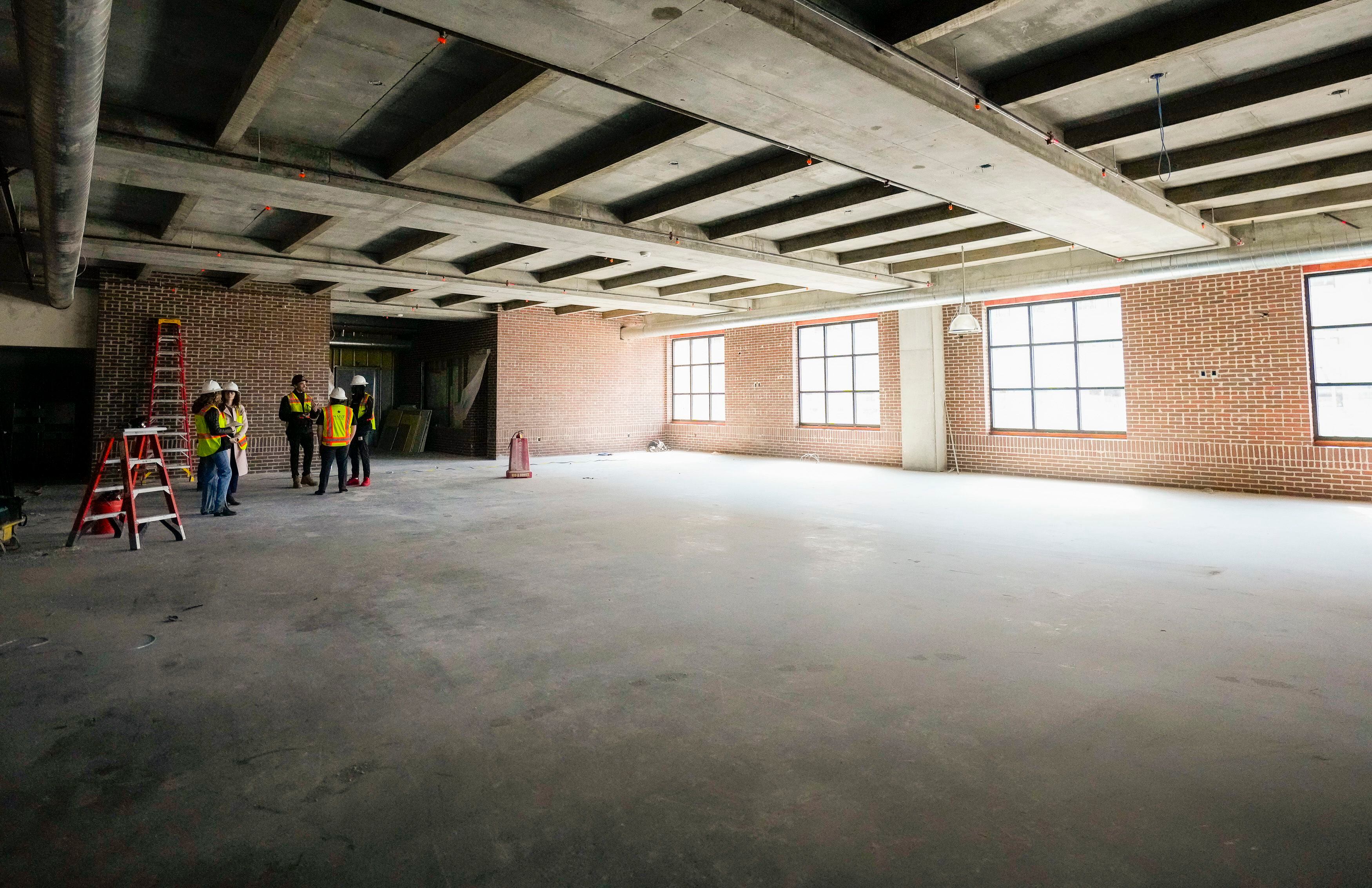 (Bethany Baker | The Salt Lake Tribune) Employees for Salt Lake Crossing, a new apartment complex set to open in downtown in May, give a tour at the construction site in downtown Salt Lake City on Friday, March 8, 2024.
