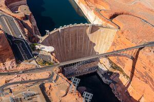 (Ecoflight) An aerial view of the Glen Canyon Dam and Lake Powell, Thursday, April 14, 2022. As Lake Powell has fallen to record low water levels in recent years, hydroelectricity generated at the dam has been reduced.