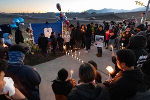 (Francisco Kjolseth | The Salt Lake Tribune) More that a hundred people gather at the candlelight vigil of Hunter High football players Paul Tahi , 15, Tivani Lopati, 14, and Ephraim Asiata, 15, on Friday, Jan 14, 2022, in West Valley City, near Hunter High School along 4100 South at Mountain View Corridor. Paul Tahi and Tivani Lopati were killed in a shooting, while Ephraim Asiata remains in critical condition.