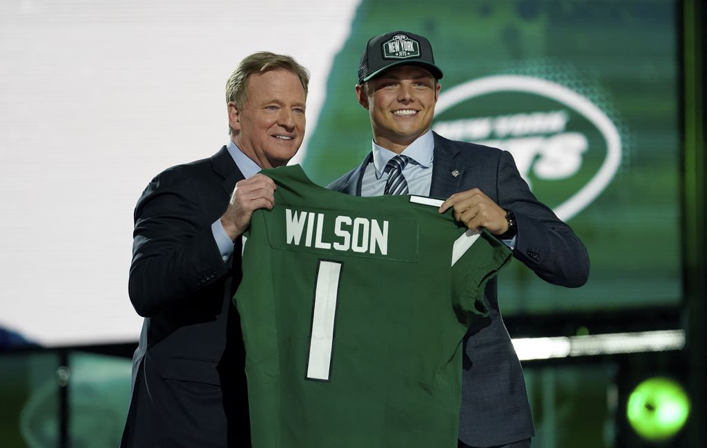 (Steve Luciano | AP) BYU quarterback Zach Wilson, right, poses for a photo with NFL Commissioner Roger Goodell after being drafted by the New York Jets in the first round of the NFL football draft, Thursday, April 29, 2021, in Cleveland.