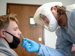 (Chris Samuels | The Salt Lake Tribune) Gideon Crane, left, is tested for COVID-19 at a center run by Granite School District and the Salt Lake County Department of Health near Thomas Jefferson Junior High in Kearns, Tuesday, Jan. 4, 2022.