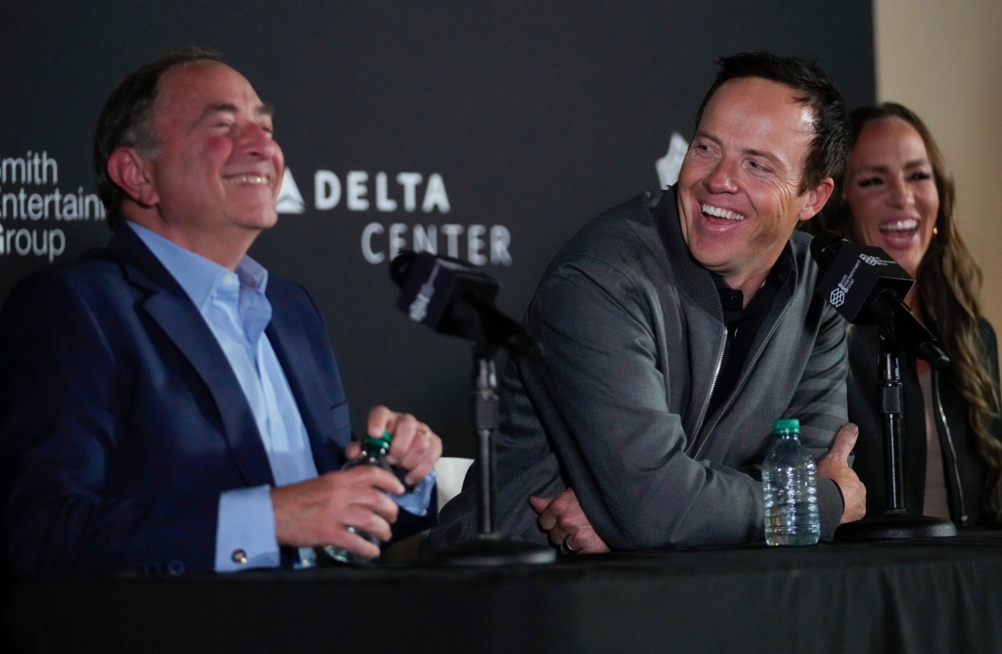 (Bethany Baker  |  The Salt Lake Tribune) SEG owner Ryan Smith, center, laughs as he looks at NHL Commissioner Gary Bettman during a press conference announcing a new National Hockey League team owned by Smith Entertainment Group at the Delta Center in Salt Lake City on Friday, April 19, 2024.