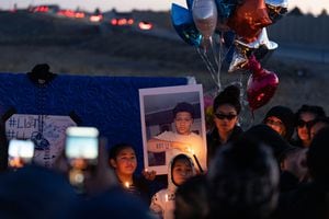(Francisco Kjolseth | The Salt Lake Tribune) More that a hundred people gather at a candlelight vigil for Hunter High football players Paul Tahi , 15, Tivani Lopati, 14, and Ephraim Asiata, 15, on Friday, Jan 14, 2022, in West Valley City, near Hunter High School along 1400 South at Mountain View Corridor. Paul Tahi and Tivani Lopati were killed in the shooting, while Ephraim Asiata is still in the hospital.