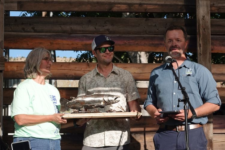 (Courtesy of Trout Unlimited) Jordan Nielson, right, and Zach Ahrens, center, of Trout Unlimited present Helper Mayor Lenise Peterman with the first  Community Action Towards Conservation Habitat (CATCH) award to recognize the town's effort to restore a six-mile stretch of the Price River on Aug. 19, 2023.