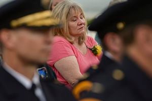 (Leah Hogsten  |  The Salt Lake Tribune)  Julie Cawley Hanson becomes emotional after placing a carnation in memory of her brother Detective James W. Cawley, who died in the line of duty in 2003. In honor of Police Week, the Salt Lake City Police Department honored its fallen officers with a memorial service and a 21-gun salute at the Public Safety Building on May 16. Peace Officers Memorial Day andÊPolice WeekÊpay tribute to the local, State, and FederalÊlaw enforcementÊofficers who serve and protect us with courage and dedication.