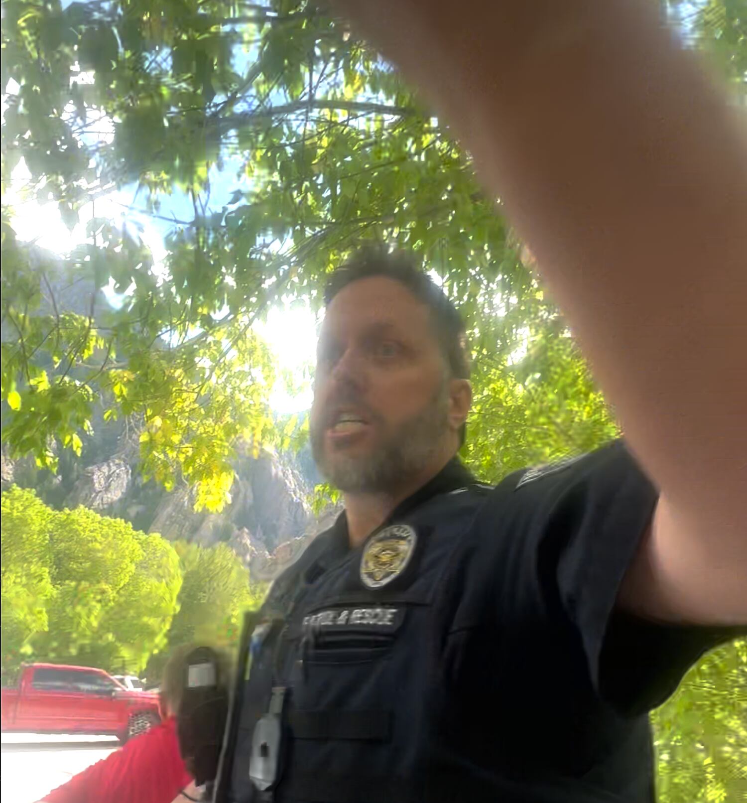 (Courtesy of Kamal Bewar) Unified Police Department Officer Dave Wilson appears in a screengrab from a video, recorded during Wilson's interaction with Bewar at Storm Mountain Picnic Area on Sept. 10, 2023.