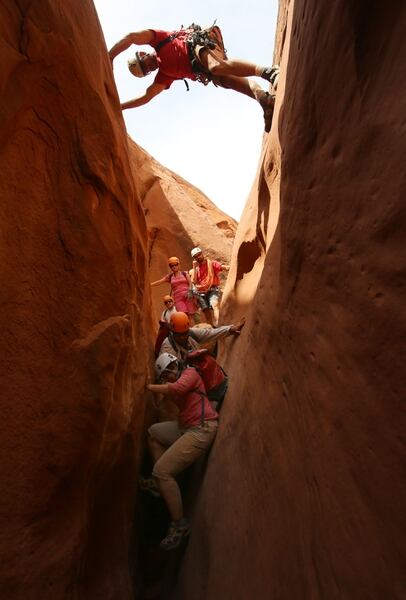 (Francisco Kjolseth | Tribune File Photo) Slot canyon guide Rick Green gets a bird's-eye view on the progress being made by his group through one of the many slot canyons in the Grand Staircase-Escalante National Monument.