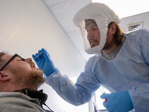(Chris Samuels | The Salt Lake Tribune) Christopher Lee, left, is tested for COVID-19 at a center run by Granite School District and the Salt Lake County Department of Health near Thomas Jefferson Junior High in Kearns, Tuesday, Jan. 4, 2022.