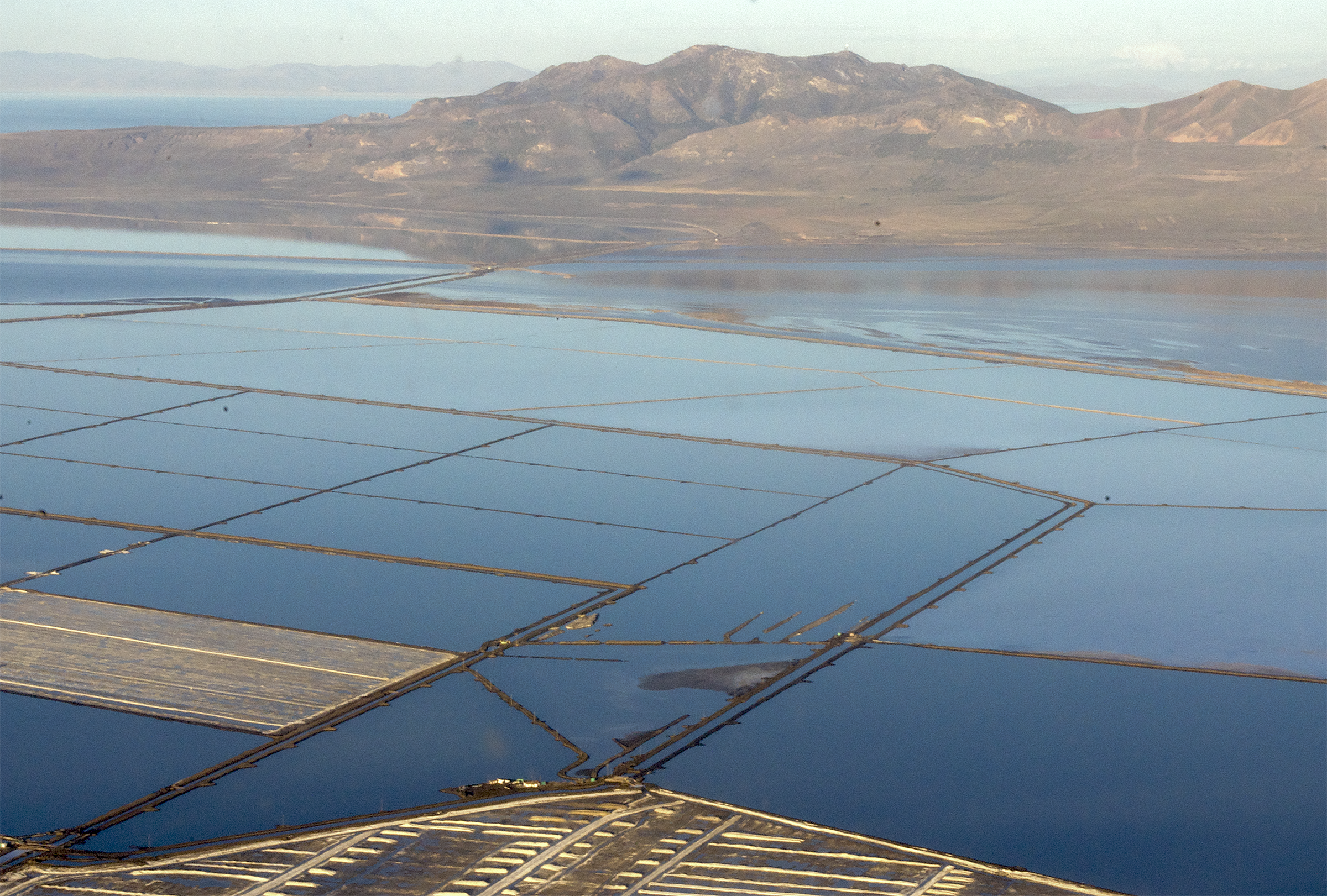 (Megan Banta | The Salt Lake Tribune) Evaporation ponds and Promontory Point pictured during a flyover of the Great Salt Lake with EcoFlight on Tuesday, April 9, 2024.