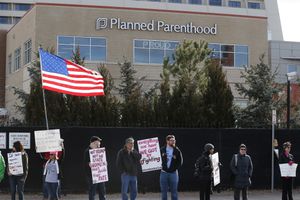 (Brennan Linsley | AP Photo) In this 2017 file photo, counter-protesters hold signs supporting a woman's right to choose abortion, as nearby anti-abortion activists held a rally in front of Planned Parenthood of the Rocky Mountains in Denver. Colorado is one of the closest states with wider abortion access that Utahns could travel to for abortions if Roe v. Wade is overturned.