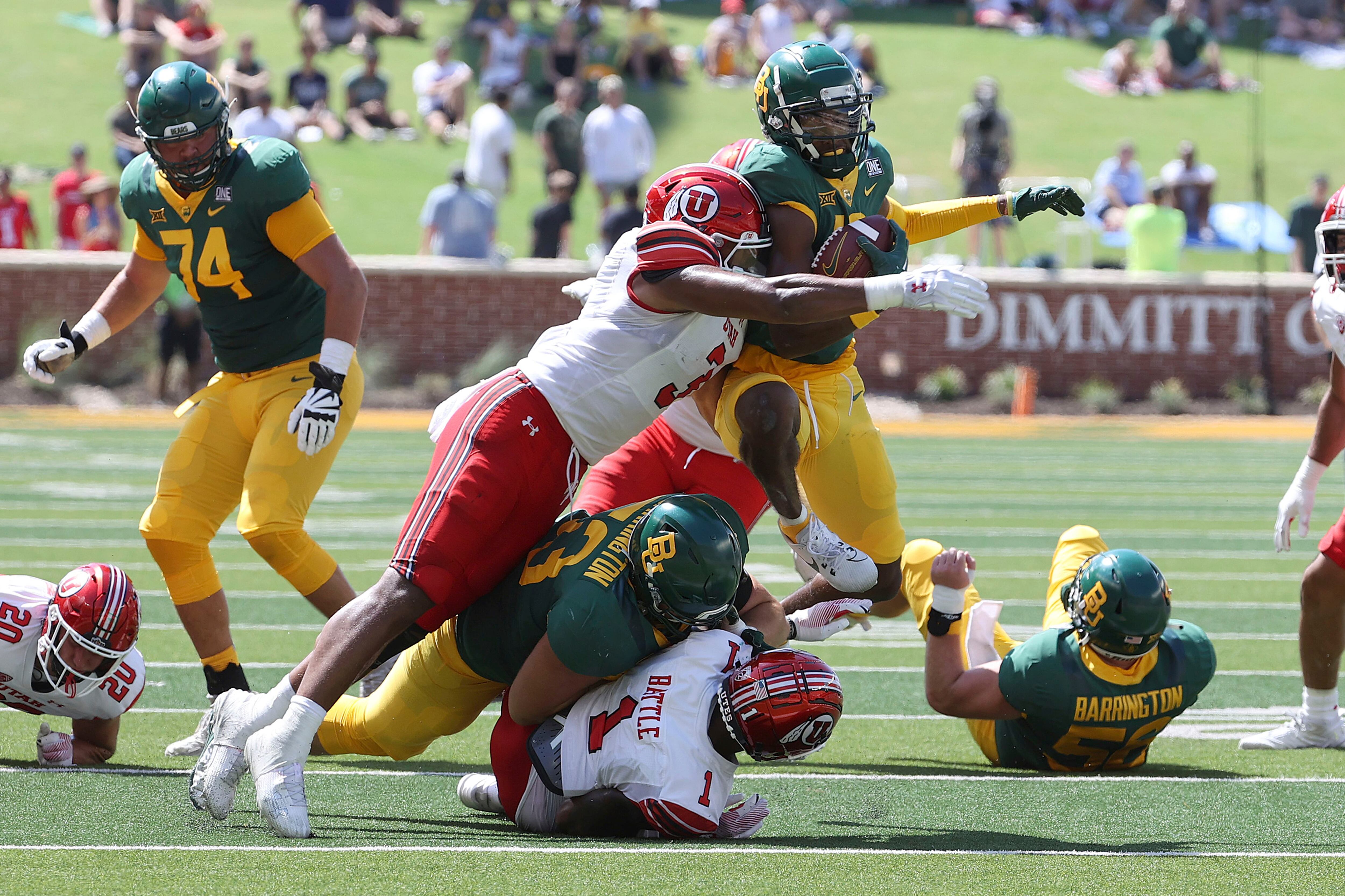 Baylor wide receiver Hal Presley (16) is tackled Utah linebacker Levani Damuni (3) in the first half of an NCAA college football game, Saturday, Sept. 9, 2023, in Waco, Texas. (AP Photo/Jerry Larson)