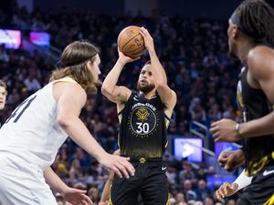 Golden State Warriors guard Stephen Curry (30) shoots against the Utah Jazz during the first half of an NBA basketball game in San Francisco, Friday, Nov. 25, 2022. (AP Photo/John Hefti)