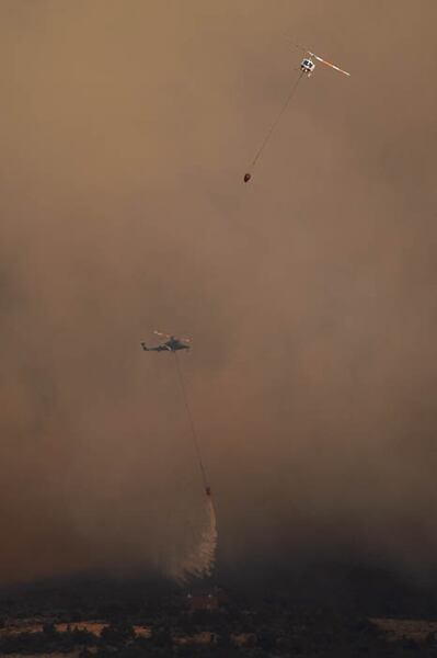 (Trent Nelson | The Salt Lake Tribune) Helicopters make drops on the Dollar Ridge Fire near Fruitland in Duchesne County, Tuesday July 3, 2018.