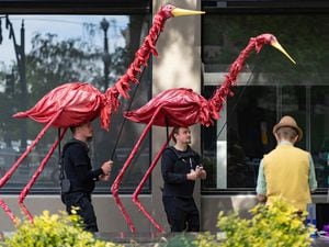 (Francisco Kjolseth | The Salt Lake Tribune) Devan Wetenkamp, left, and Jonah Ericson operate puppet flamingoes as Salt Lake City hosts Busker Fest along Main Street and Gallivan Ave., with traveling and local street performers on Saturday, May 27, 2021. This year's version of Busker Fest happens June 24-25, 2022, and organizers are seeking applications from performers.