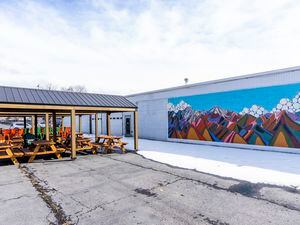 (Rick Egan | The Salt Lake Tribune) A mural by local artist Lizzie Wenger is shown at Second Summit Hard Cider in Millcreek along with tables and chairs on Thursday, March 2, 2023.