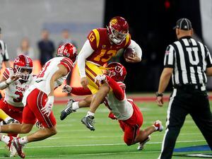 (Steve Marcus | AP) Southern California quarterback Caleb Williams (13) is tackled by Utah safeties R.J. Hubert (11) and Cole Bishop (8) during the first half of the Pac-12 Conference championship NCAA college football game Friday, Dec. 2, 2022, in Las Vegas.