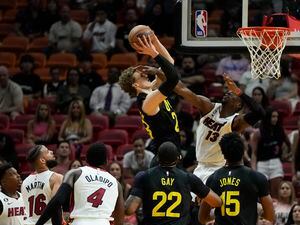 Miami Heat center Bam Adebayo fouls Utah Jazz forward Lauri Markkanen during the first half of an NBA basketball game, Monday, March 13, 2023, in Miami. (AP Photo/Rebecca Blackwell)