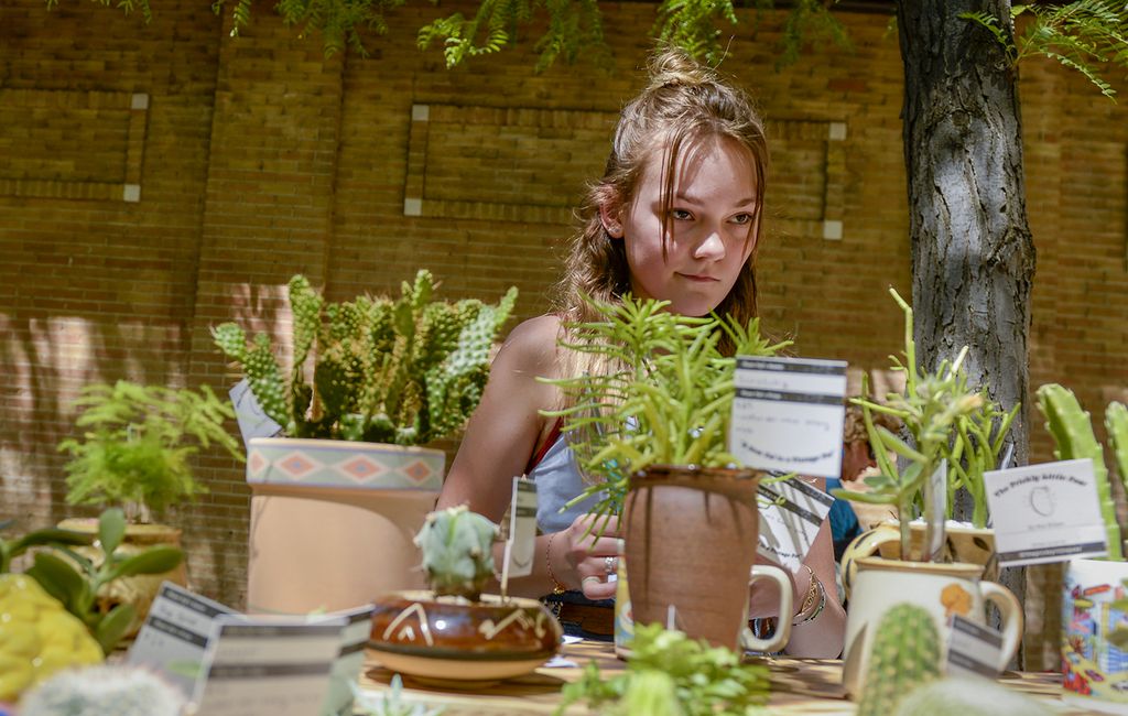 (Leah Hogsten | The Salt Lake Tribune) Ava Brown, 13, from Holladay, sells cactuses and other succulent plants, repotted in vintage ceramic containers at the 2019 Craft Lake City DIY Festival. She was among the sellers on Kid Row, where children 14 and under make and sell their products. Craft Lake City’s 2021 DIY Festival kicks off Friday, August 13 and runs through Sunday, August 15.