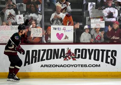 Arizona Coyotes' Dylan Guenther skates past fans as players warm up for an NHL hockey game against the Edmonton Oilers on Wednesday, April 17, 2024, in Tempe, Ariz. The Coyotes are moving to Salt Lake City. (AP Photo/Ross D. Franklin)