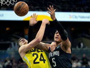Orlando Magic's Paolo Banchero (5) loses control of the ball as he collides with Utah Jazz's Walker Kessler (24) during the first half of an NBA basketball game, Thursday, March 9, 2023, in Orlando, Fla. (AP Photo/John Raoux)