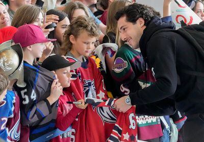 (Francisco Kjolseth  |  The Salt Lake Tribune) Hockey player Sean Durzi signs autographs for young fans for the airport arrival of the new NHL team in Salt Lake City on Wednesday, April 24, 2024.
