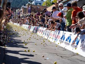 (Rick Egan | The Salt Lake Tribune) 15,000 golf balls, roll down Main Street in Park City during the "Running of the Balls," which is part of the Miners' Day celebration, Monday, Sept. 5, 2022.