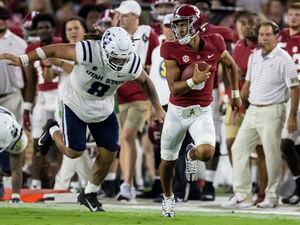 (Vasha Hunt | AP) Alabama quarterback Bryce Young, front right, runs with the ball against Utah State defensive lineman Hale Motu'apuaka (8) during the first half of an NCAA college football game Saturday, Sept. 3, 2022, in Tuscaloosa, Ala.