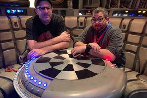 (Photo courtesy of Bryan Young) Jeremy Harmon, left, and Bryan Young sit at the holochess table inside the Smuggler's Run ride at Star Wars: Galaxy's Edge at Disneyland on May 29, 2019.