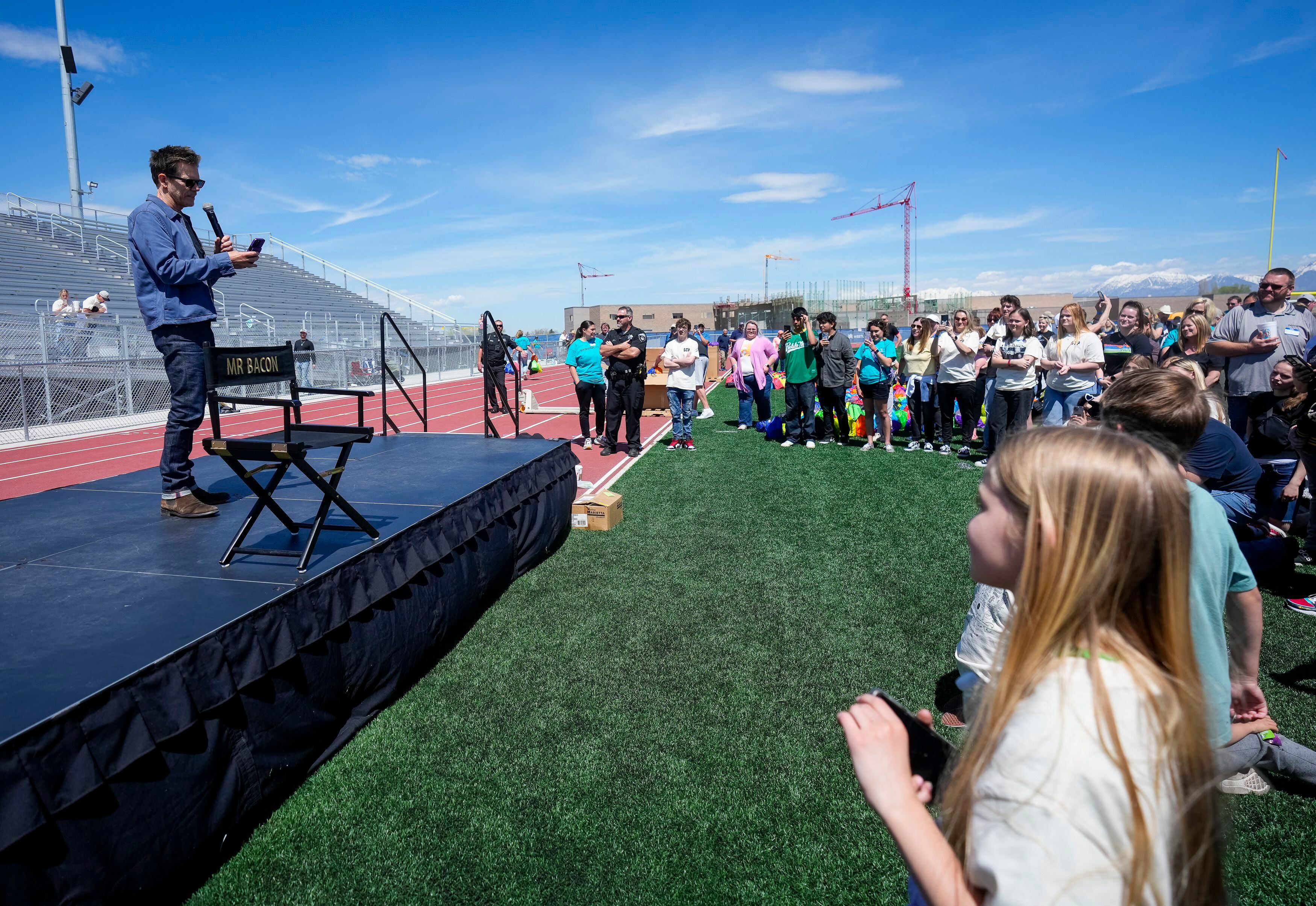 (Bethany Baker  |  The Salt Lake Tribune) Kevin Bacon prepares to take a video with the crowd following a charity event to commemorate the 40th anniversary of the movie "Footloose" on the football field of Payson High School in Payson on Saturday, April 20, 2024.