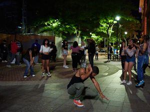 (Bridget Bennett | The New York Times) A sidewalk dance party in downtown Salt Lake City on Sept. 16, 2022. Salt Lake City’s downtown population is expected to double in the next two years, as residential towers, food halls and whiskey bars sprout against the backdrop of the Wasatch Mountains.