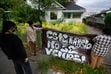 (Francisco Kjolseth | The Salt Lake Tribune) People put up a signs that reads “this neighborhood is not for sale!” in front of the home that Gaspar Valencia lived in for eight years before being forced out by a developer with plans to tear it down along with adjacent properties to build an apartment on the site. On Saturday, Aug. 6, 2022, the community gathered to protest the gentrification they see happening to their neighborhood. 