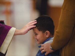 (Rachel Rydalch | The Salt Lake Tribune) Father José A. Barrera places ashes on a young boy's face for Ash Wednesday at St. Joseph the Worker Catholic Church in West Jordan in 2022.