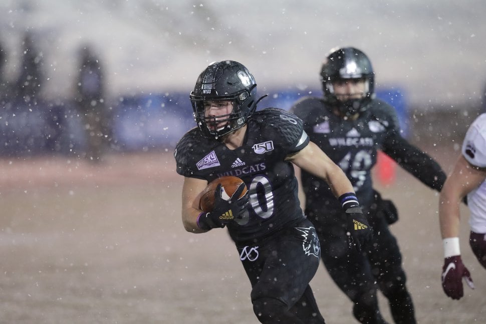 (Photo courtesy of Weber State) Running back Josh Davis stiff arms a Montana defender during Weber State's Football Championship Subdivision quarterfinal game against Montana on Friday, Dec. 13, 2019, at Stewart Stadium in Ogden. Davis, who got injured in the second quarter, came in for one play in the third quarter and scored the Wildcats' only offensive touchdown.