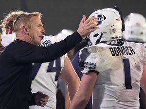 Utah State head coach Blake Anderson, left, taps quarterback Logan Bonner (1) on the head after he threw a touchdown pass against San Jose State. Anderson said the Aggies' Mountain West championship helped his team's recruiting efforts this year.
