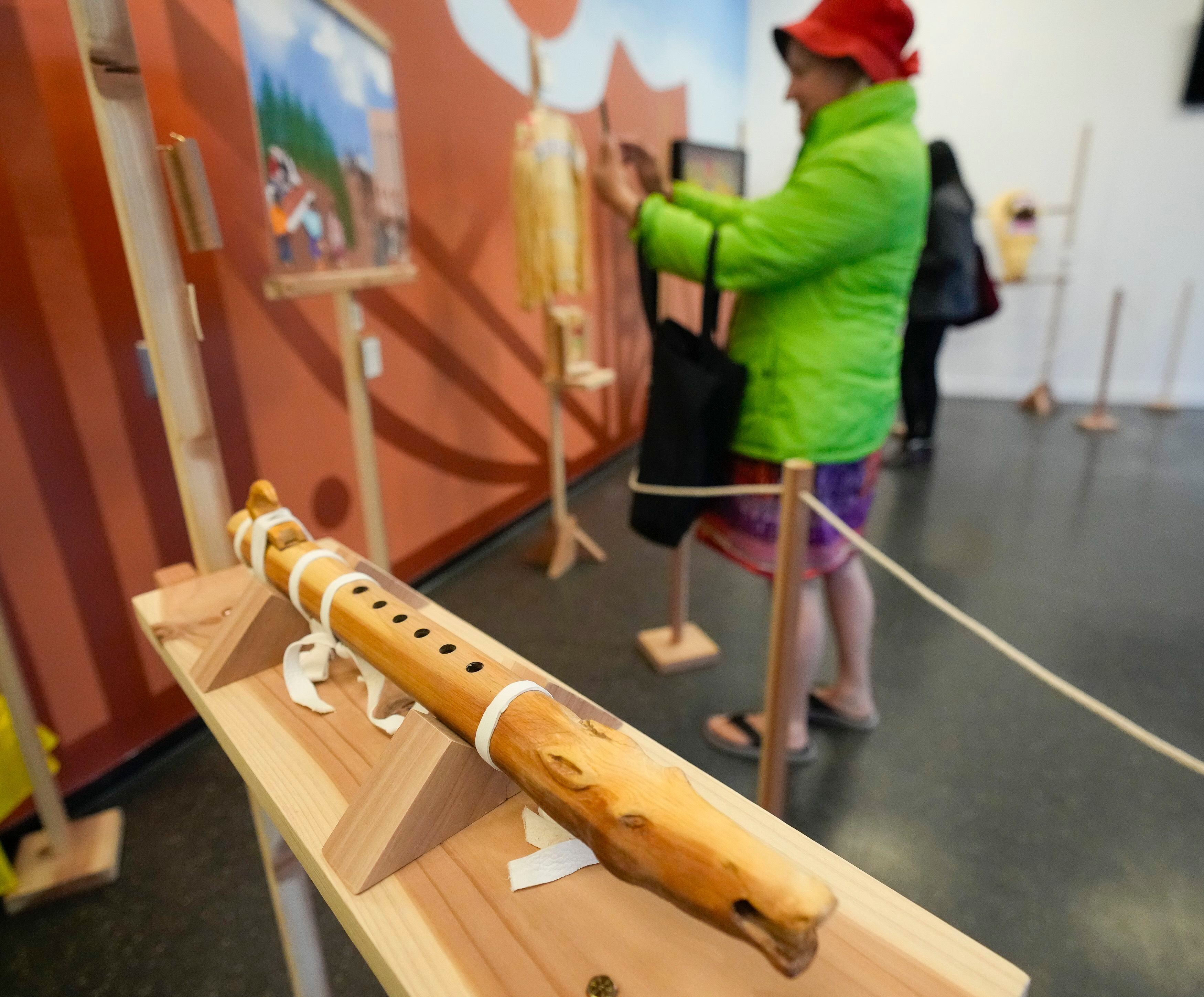 (Bethany Baker | The Salt Lake Tribune) A traditional Ute flute made from cedar by Aldean Ketchum, aka Lightning Hawk, sits on display during the opening event for the "100 Years of Silence" exhibition at The Leonardo in Salt Lake City on Saturday, March 23, 2024.