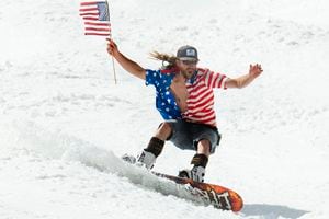 (Rick Egan  |  The Salt Lake Tribune) James Perry of Salt Lake makes his way down the hill, dressed for the Fourth of July and waving an American flag, on the last ski day of the year at Snowbird Ski resort on Thursday, July 4, 2019.