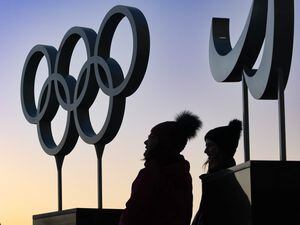 (Francisco Kjolseth | The Salt Lake Tribune) People gather near the Olympic cauldron before it is lit up on the 20-year anniversary of the Salt Lake 2002 Olympic Opening Ceremony at Rice-Eccles Stadium on Tuesday, Feb. 8, 2022.