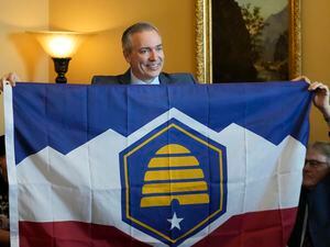 (Rick Bowmer | AP) Utah Sen. Dan McCay, R-Riverton, unfurls the state's new flag during a Senate media availability on Thursday, March 2, 2023, in Salt Lake City. Opponents of the new state flag have filed a referendum in an attempt to bypass the Legislature and let voters decide on the design.