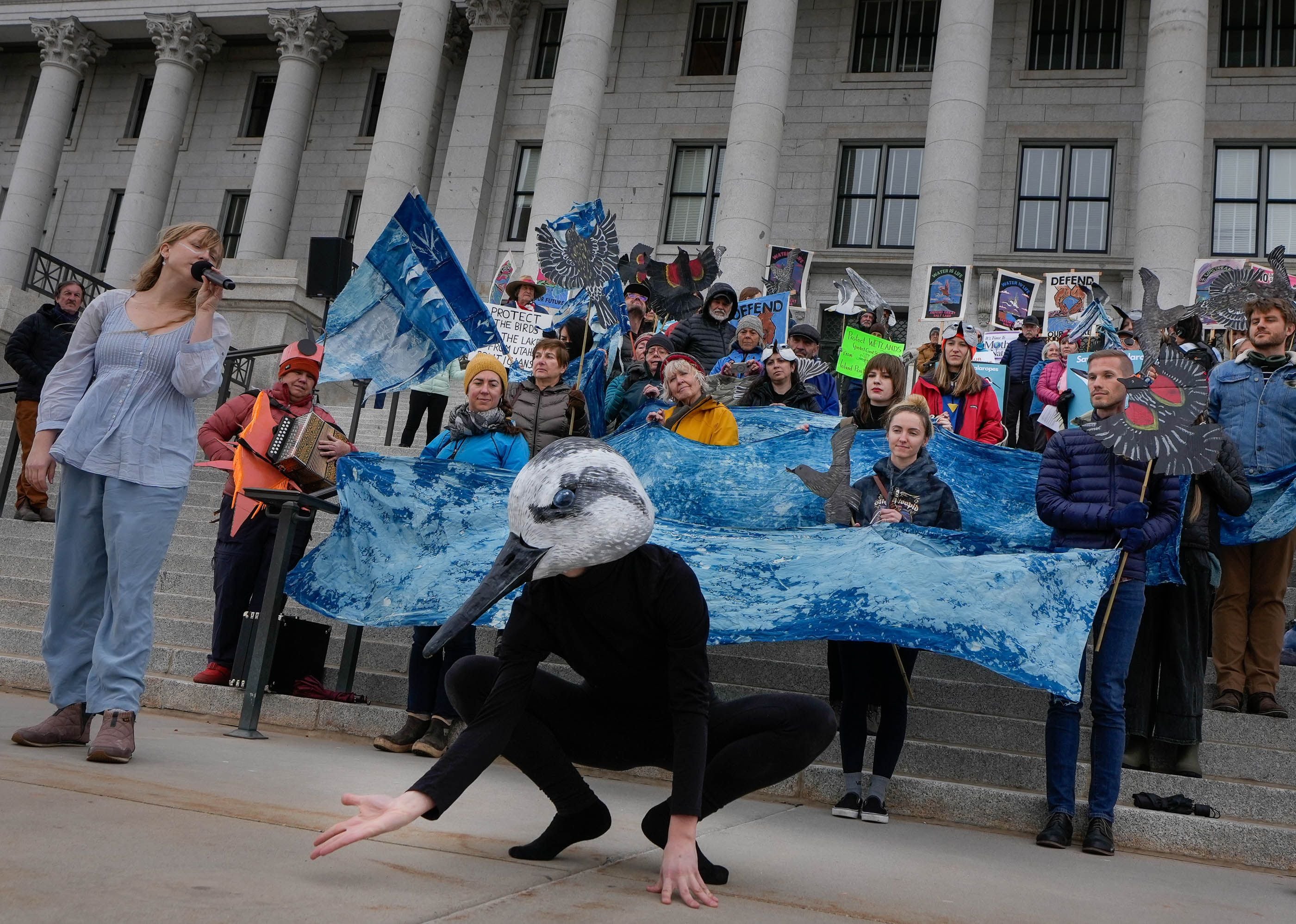 (Francisco Kjolseth  |  The Salt Lake Tribune) Eco-performance artists Sarah Ann Woodbury, left, and Bryn Watkins, representing a Wilson's phalarope, perform at the Utah Capitol on Thursday, March 28, 2024, as they join other advocates for a healthy Great Salt Lake and an threatened species act listing petition for the inland shorebird. 