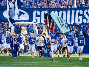 (Rick Egan | The Salt Lake Tribune) The Brigham Young Cougars take the field for football action between the Brigham Young Cougars and the Utah State Aggies, at LaVell Edwards Stadium in Provo, on Thursday, Sept. 29, 2022.