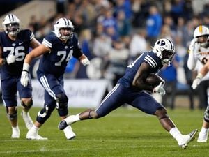 (Francisco Kjolseth | The Salt Lake Tribune) Brigham Young Cougars running back Miles Davis (19) puts in the yards as he carries the ball in football game action between the Brigham Young Cougars and the Wyoming Cowboys at LaVell Edwards Stadium in Provo, on Saturday, Sept. 24, 2022.