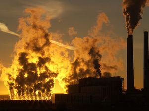 Francisco Kjolseth  |  Tribune File PhotoThe Sun rises behind steam from a cooling unit at the coal-fired Hunter power plant south of Castle Dale.                