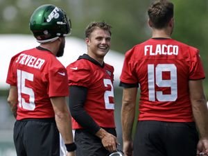 (Adam Hunger | AP) New York Jets quarterback Zach Wilson (2) laughs with quarterbacks Joe Flacco (19) and Chris Streveler during a break in drills at the NFL football team's practice facility in Florham Park, N.J., last Thursday.