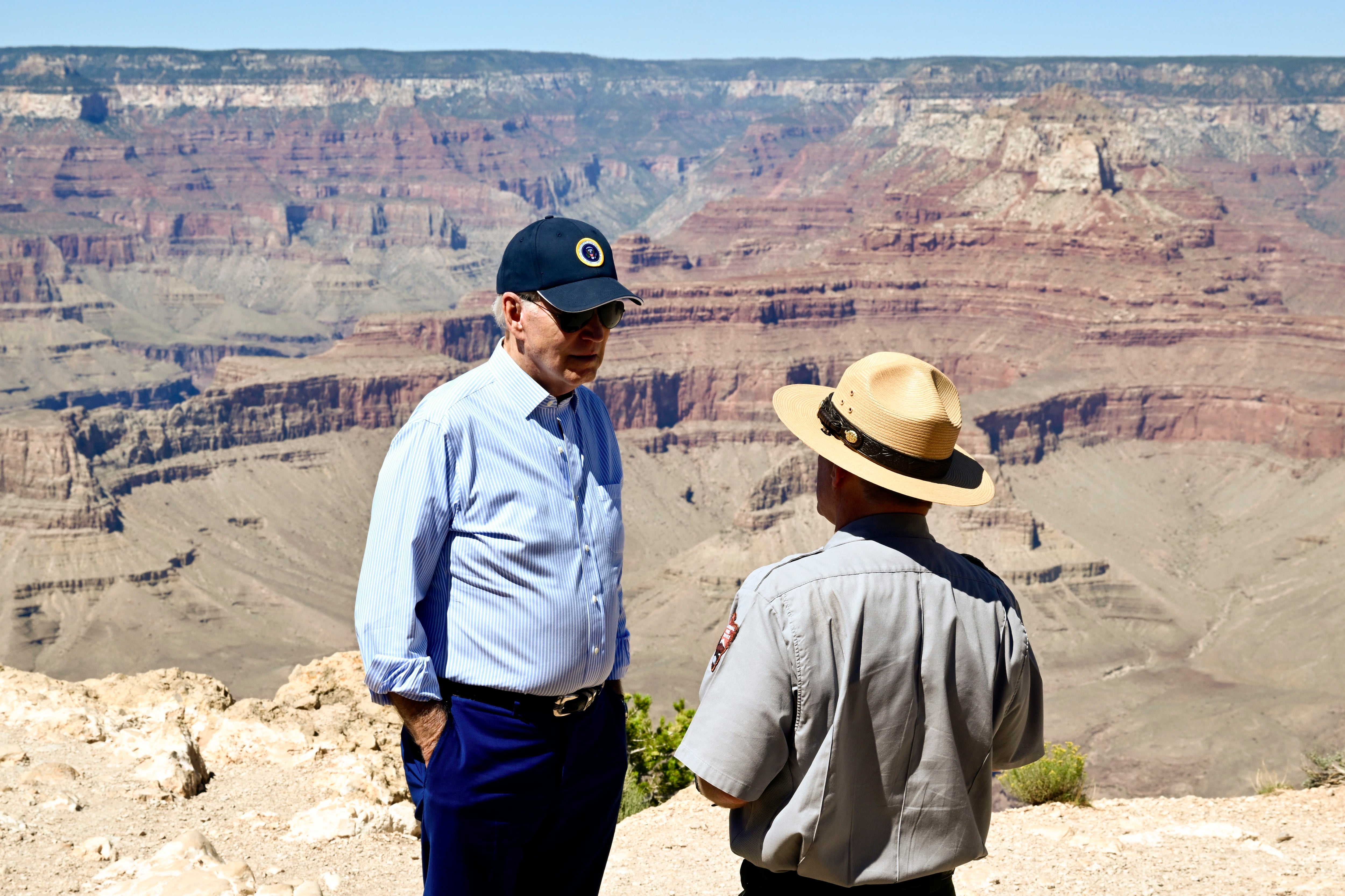 (Kenny Holston | The New York Times) President Joe Biden speaks to Ed Keable, superintendent of Grand Canyon National Park, while looking over the Grand Canyon in August 2023. Some Latter-day Saint women are abandoning their lifelong GOP ties to support the Democratic president against Republican Donald Trump in 2024.